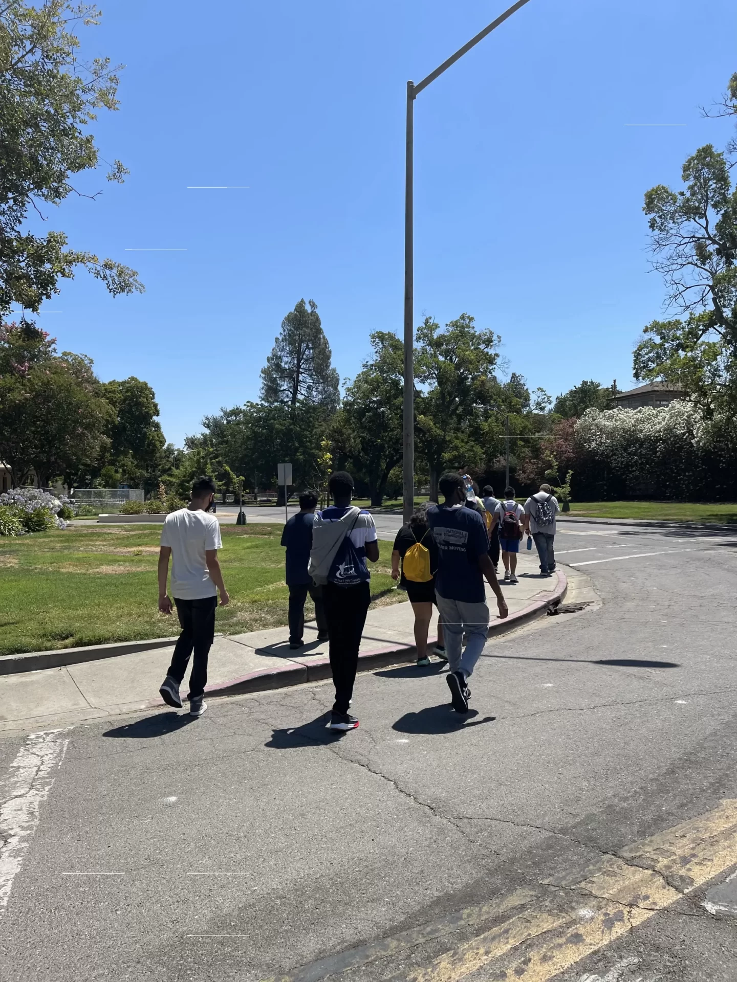 PACT Students crossing street at crosswalk by school